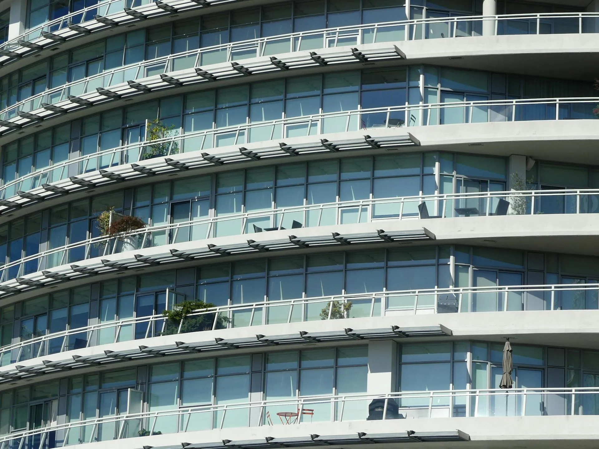 Modern apartment building facade with curved glass windows and balconies — typical strata and body-corporate context